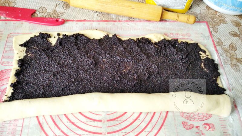 Раскладываем на листы теста мак и начинаем сворачивать рулет